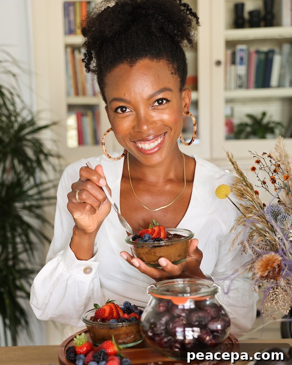 Jenné Claiborne holding a dish of vegan chocolate mousse. 