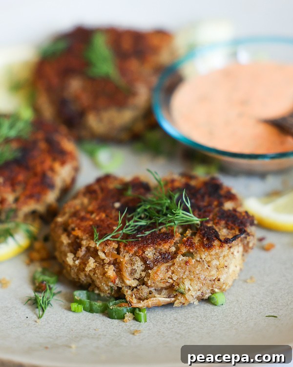 Lion's Mane Crab Cakes on a plate with dipping sauce.