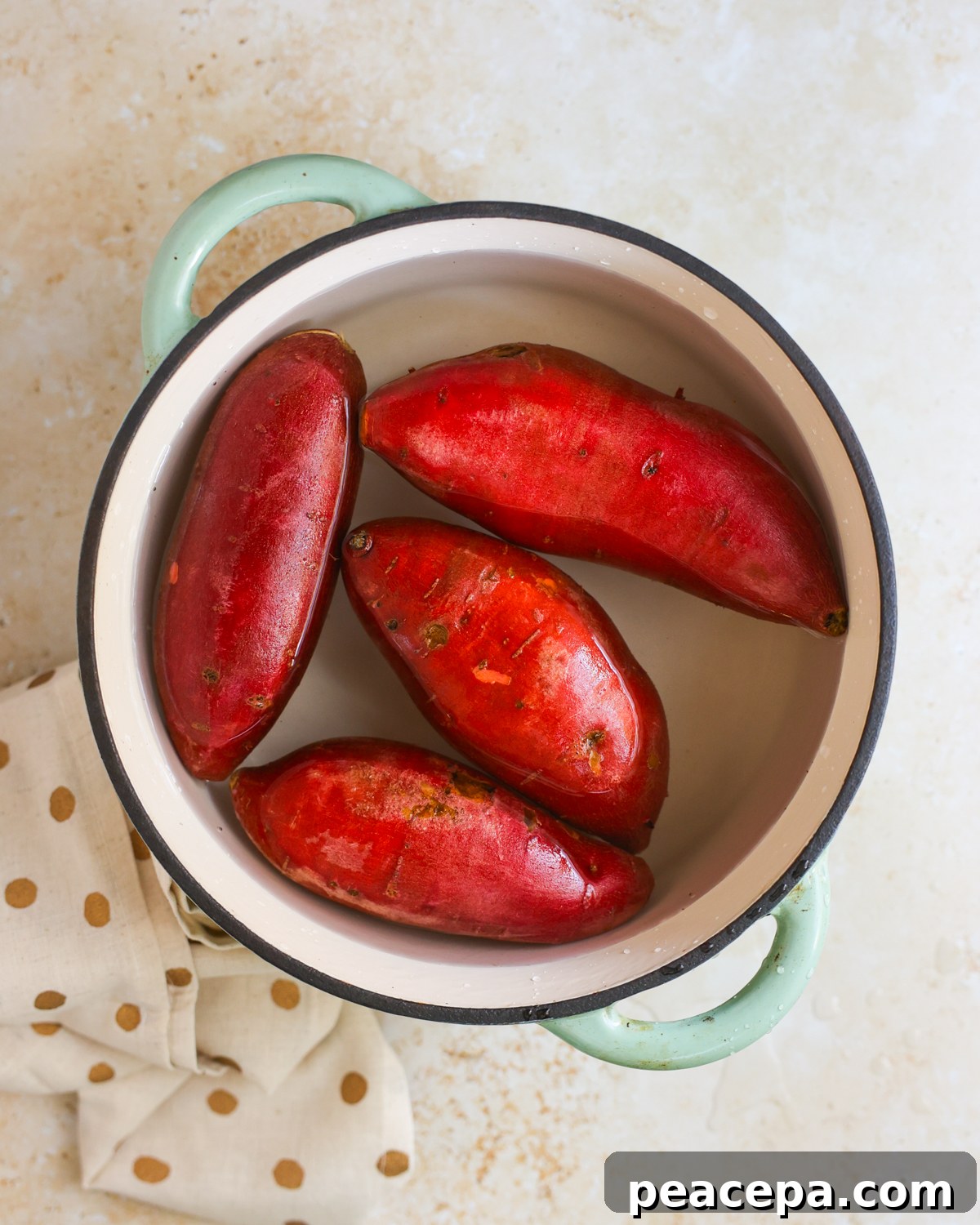 overhead of sweet potatoes in pot of water