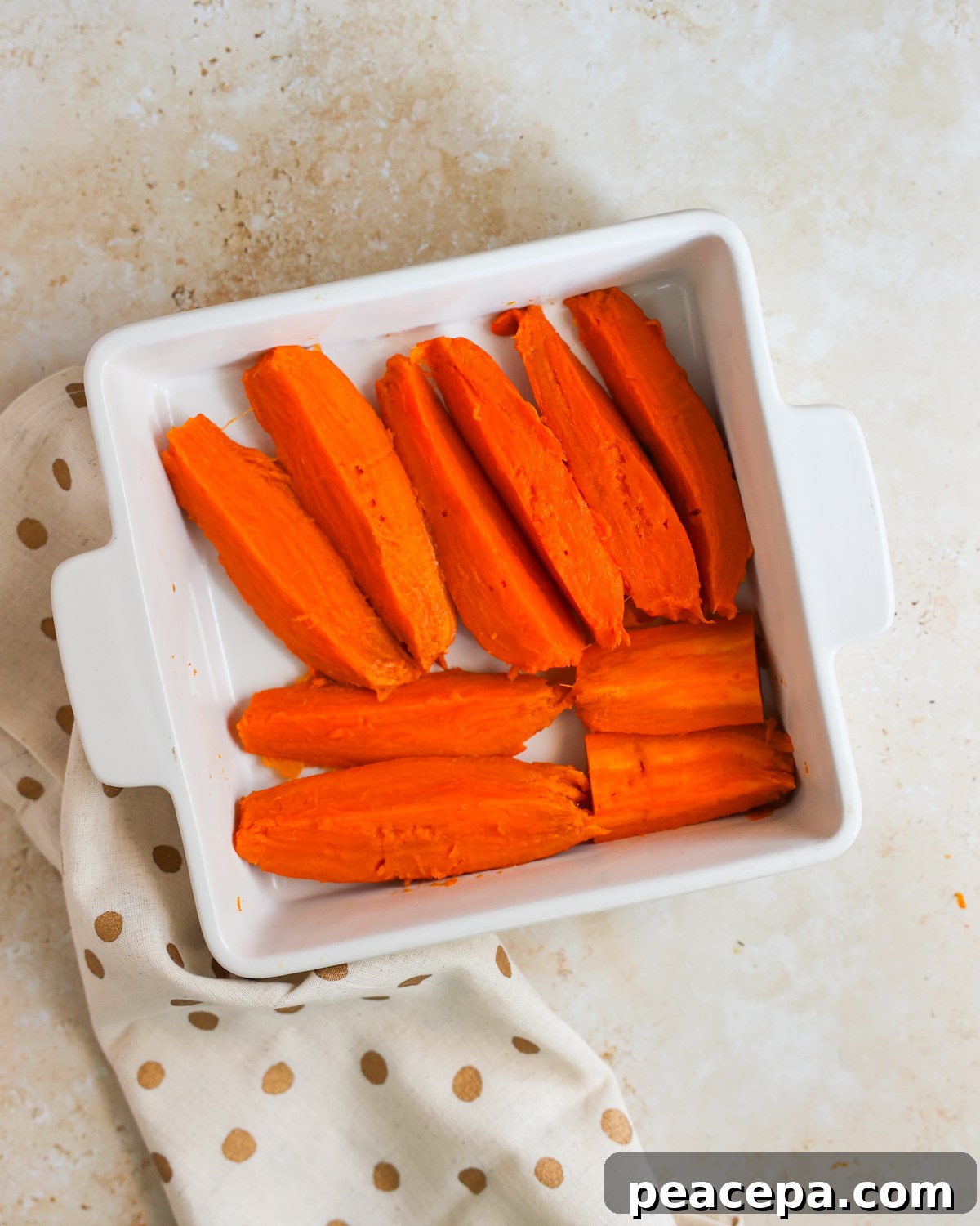 sliced sweet potatoes in baking dish