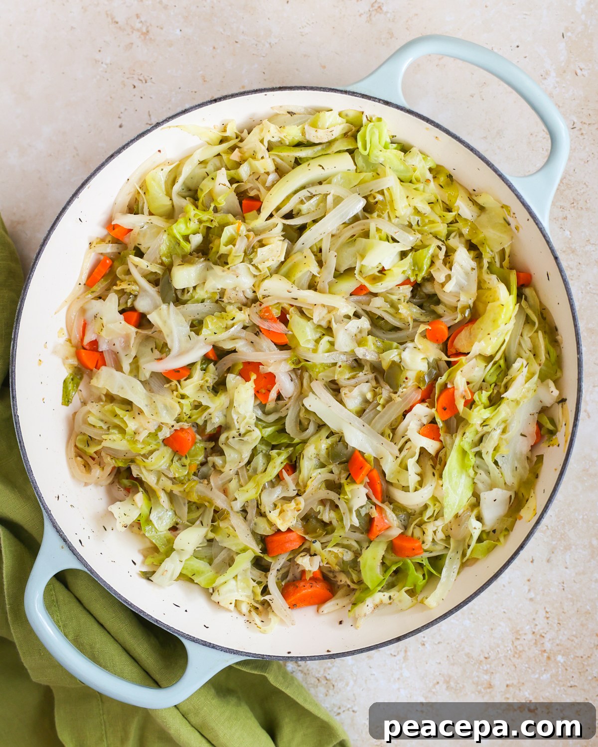Braised cabbage in a skillet.