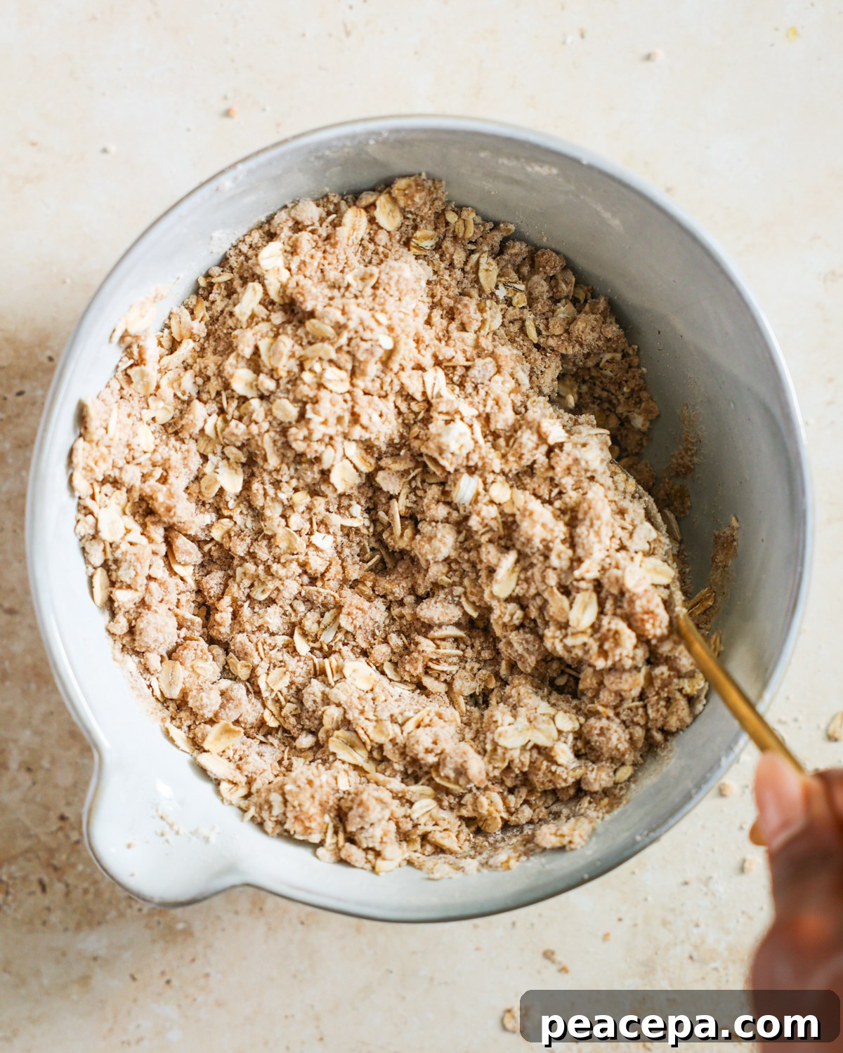 Stirring the butter into the oat crumble topping. 