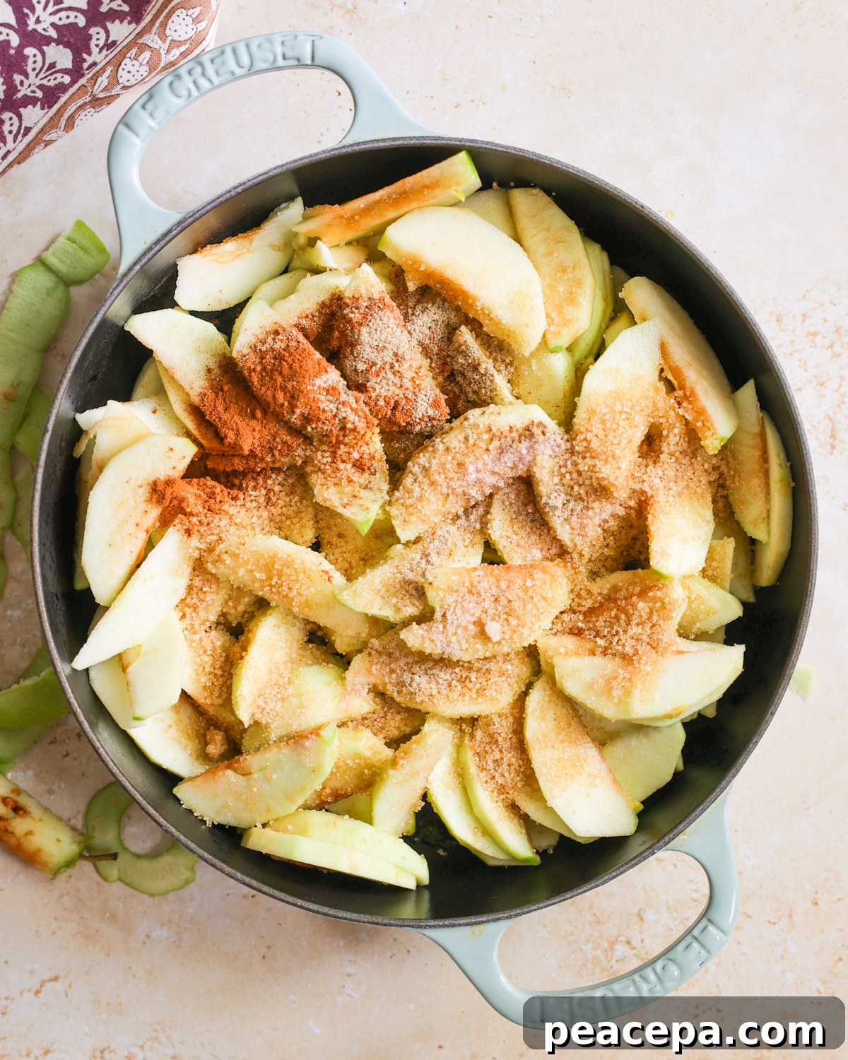 Spices and sugar on apple slices.