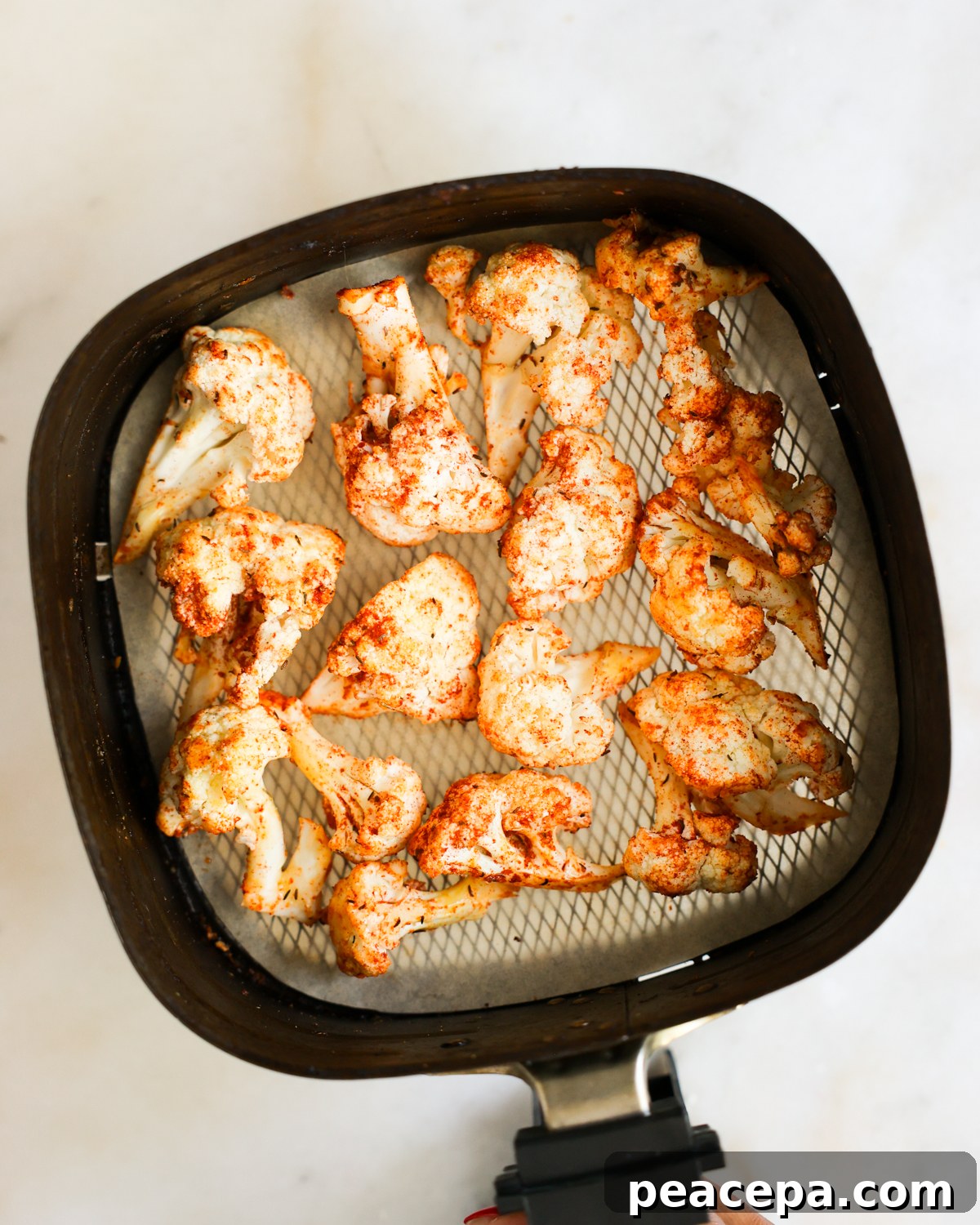 raw In a large bowl, toss the cauliflower florets with the oil. Then toss with the spices until every piece is evenly coated.