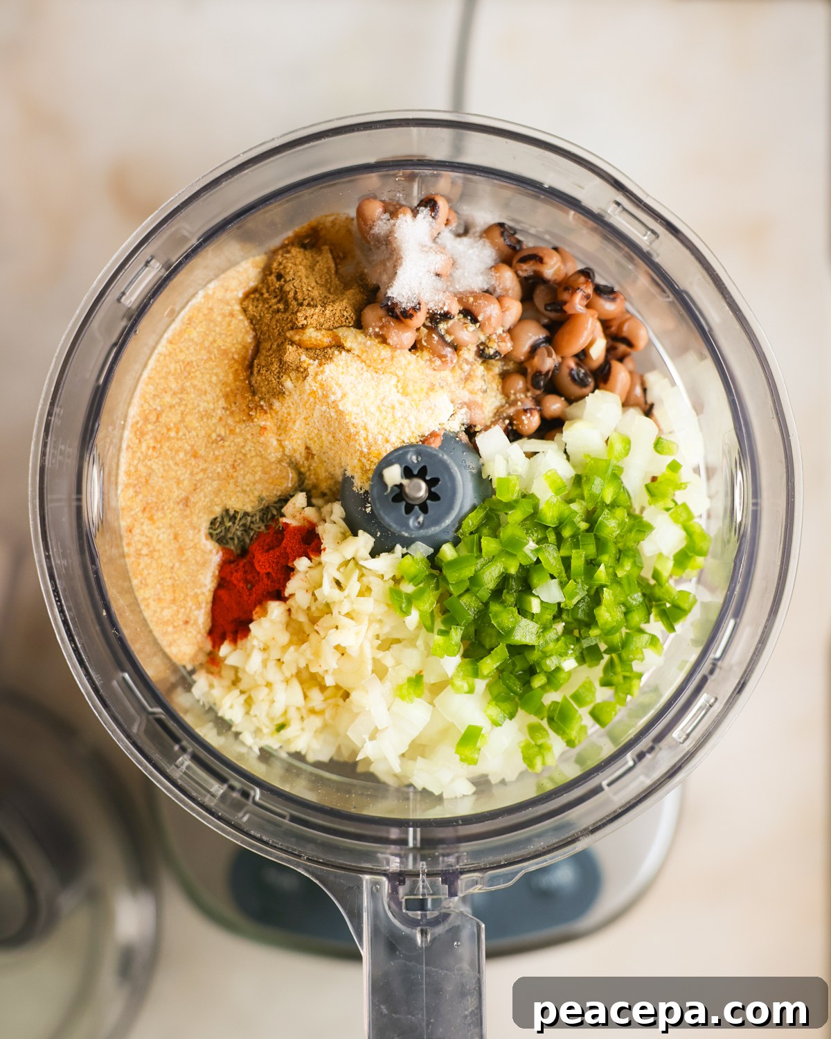 Fritter ingredients in a food processor before blending.