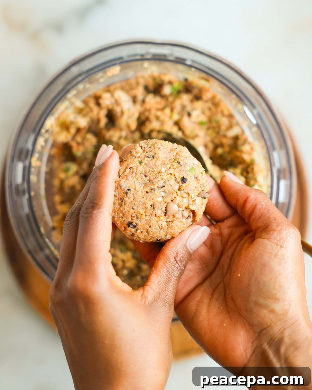 Shaping black eyed pea fritters in hand.