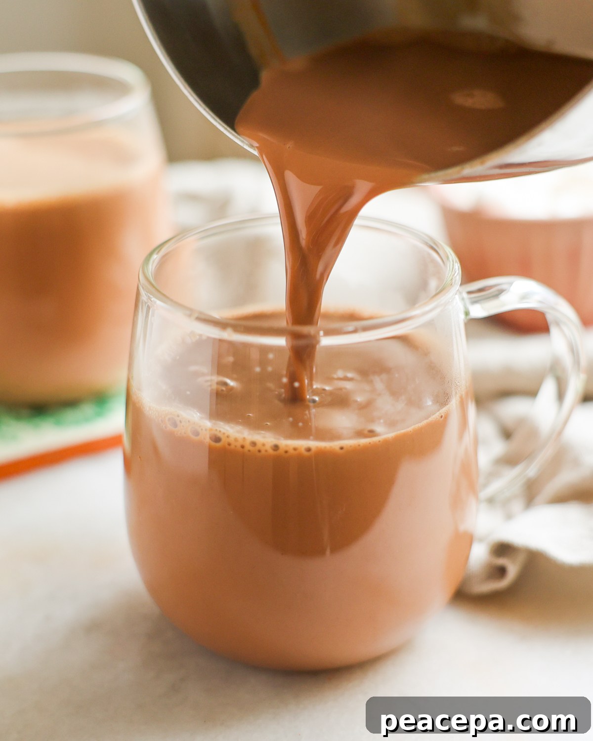 pouring hot chocolate into mug