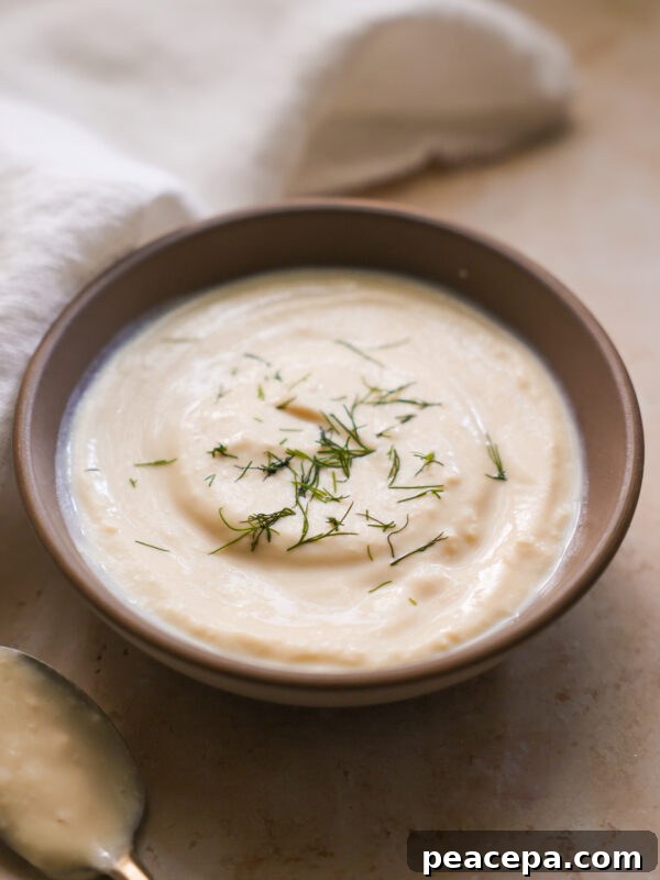 vegan sour cream in a bowl topped with dill