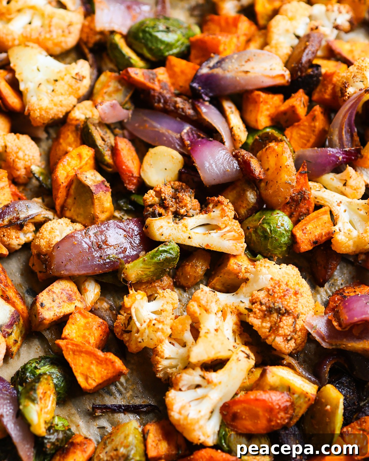 Roasted vegetables on a baking pan.