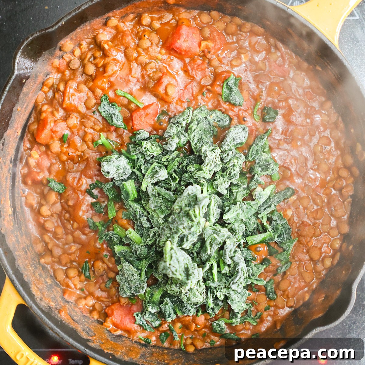 Frozen spinach on cooking lentils. 