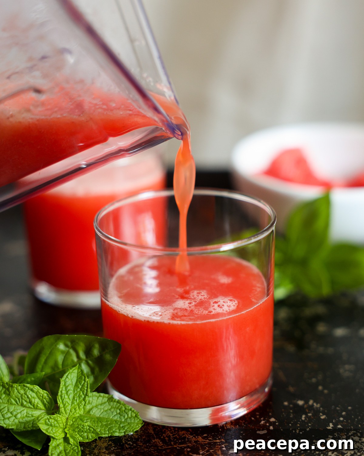 watermelon smoothie pouring into glass