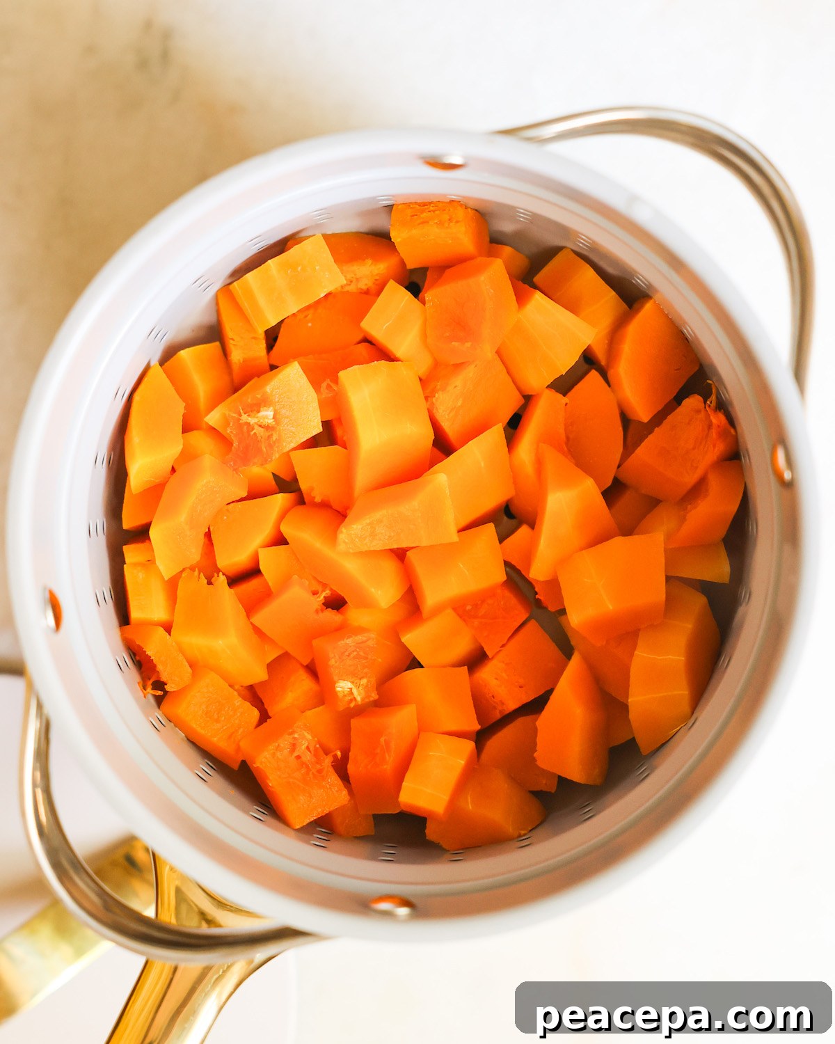 overhead of steamed butternut squash in a pot