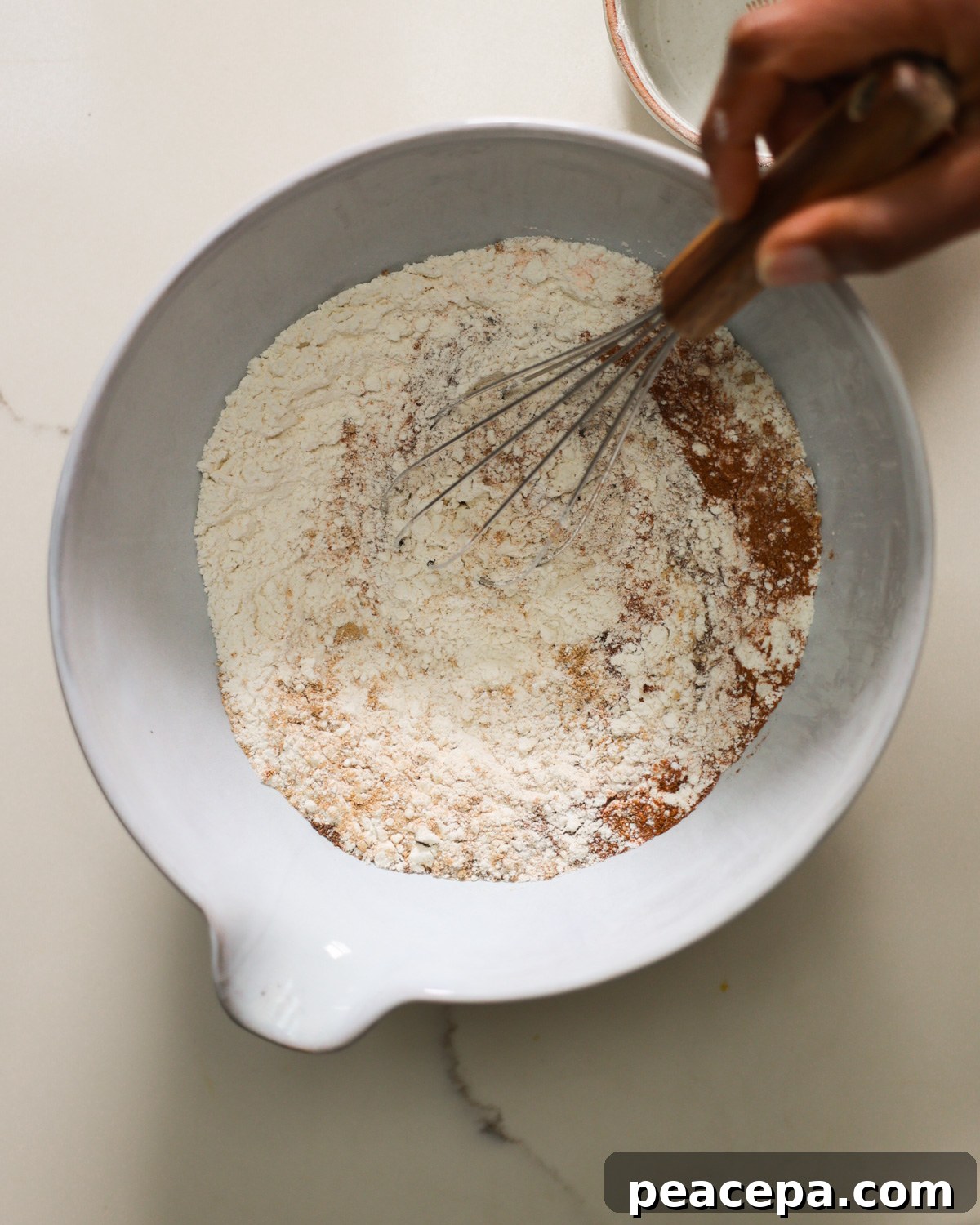 overhead mixing dry ingredients in bowl