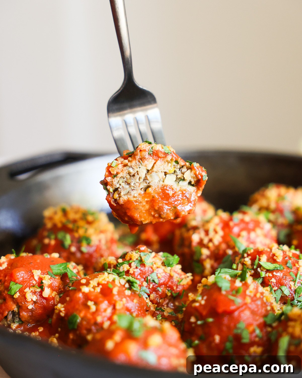 Vegan meatball on fork.