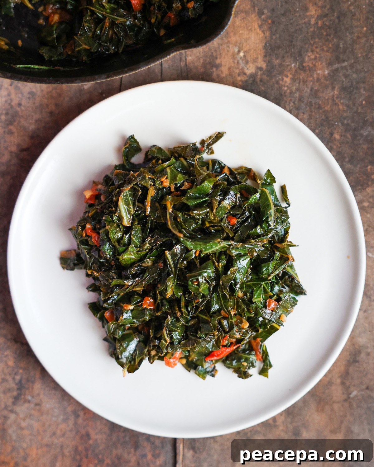 Cooked collard greens on a white plate.