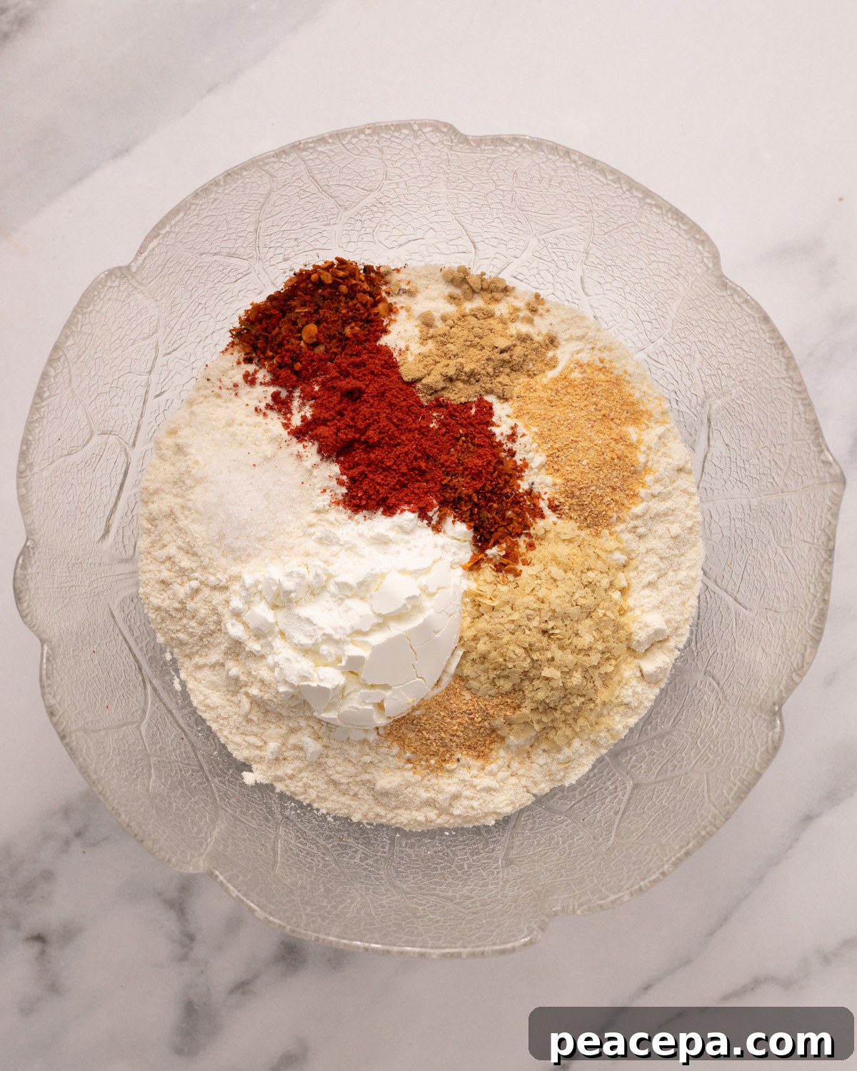 overhead of dry ingredients for vegan fried chicken batter in a glass bowl