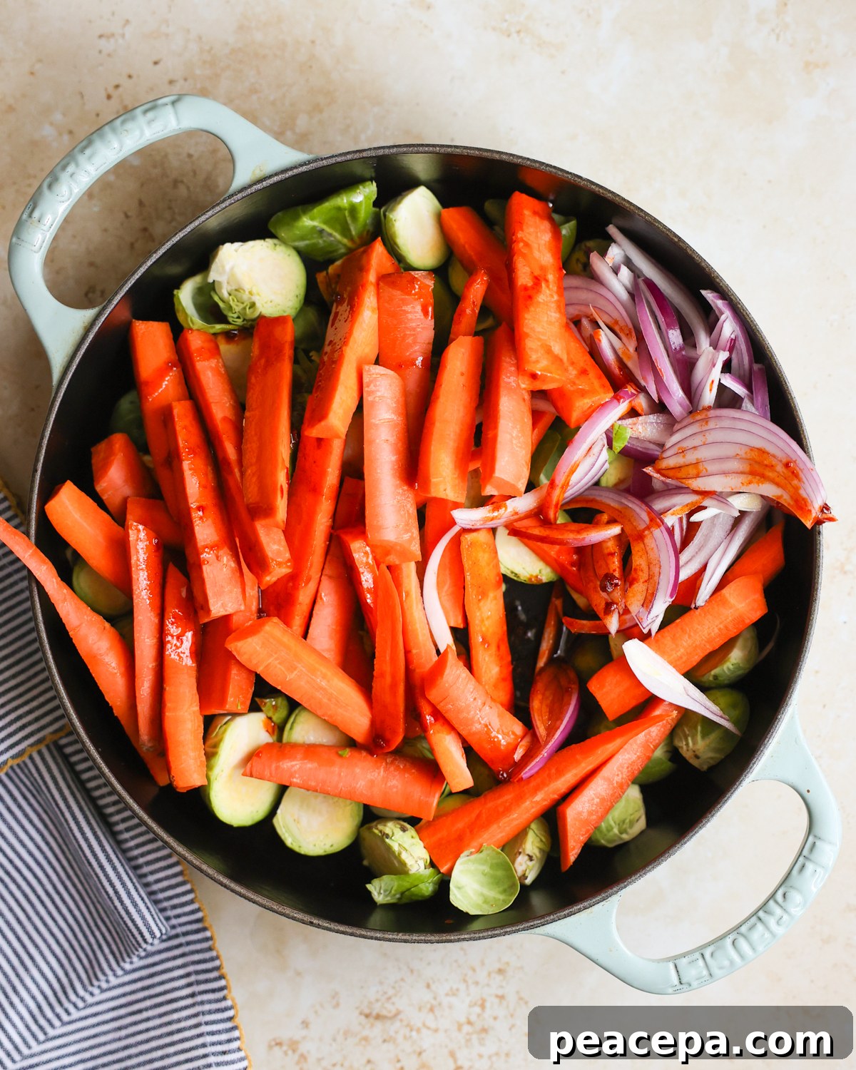 overhead chopped veggies in skillet with spices