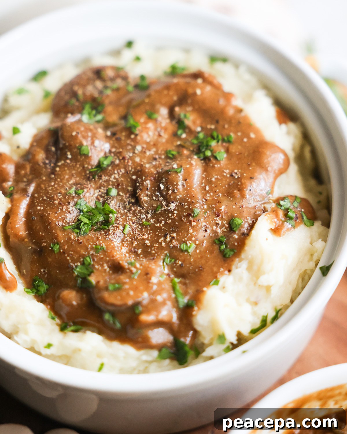 closeup of vegan mashed potatoes topped with mushroom gravy