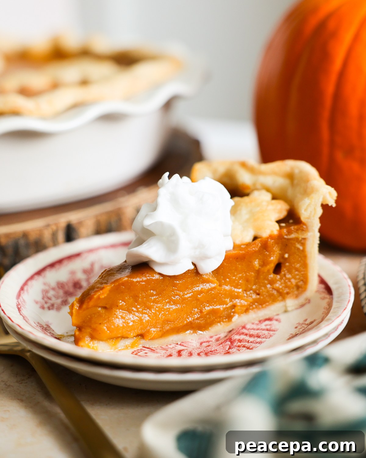 slice of pumpkin pie with whipped cream