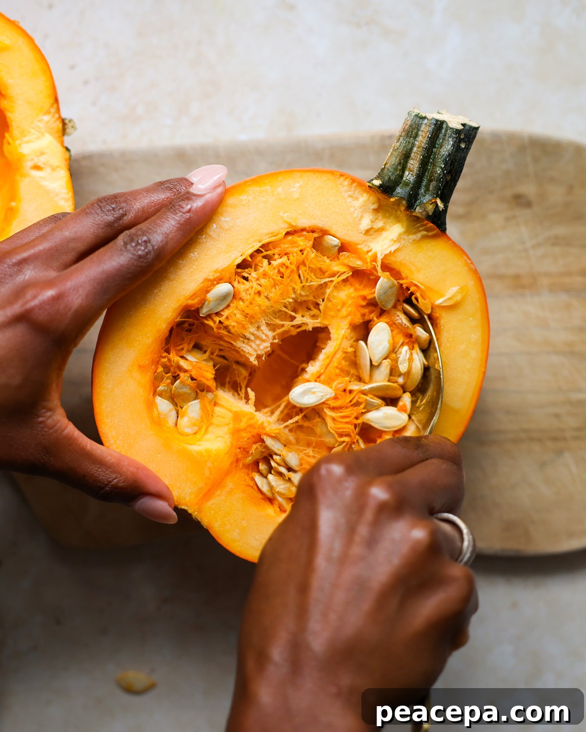 overhead scooping seeds from pumpkin