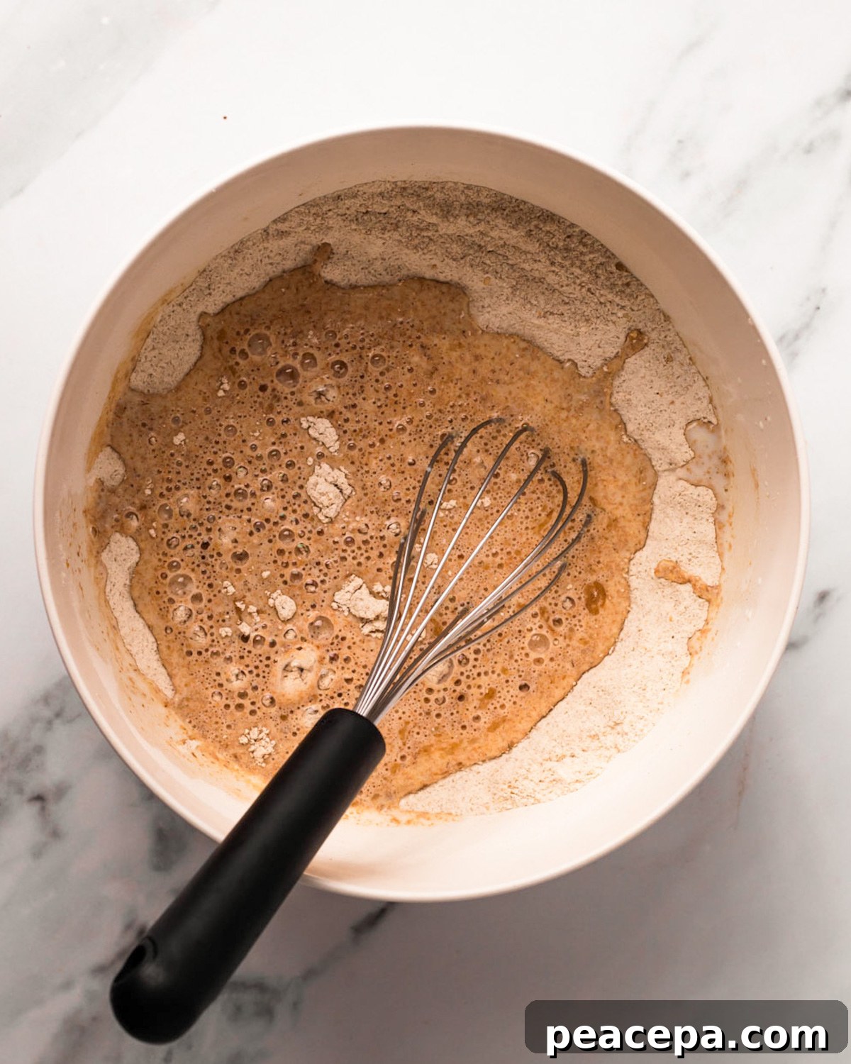 An overhead shot of a bowl of the vegan pancake batter before whisking.