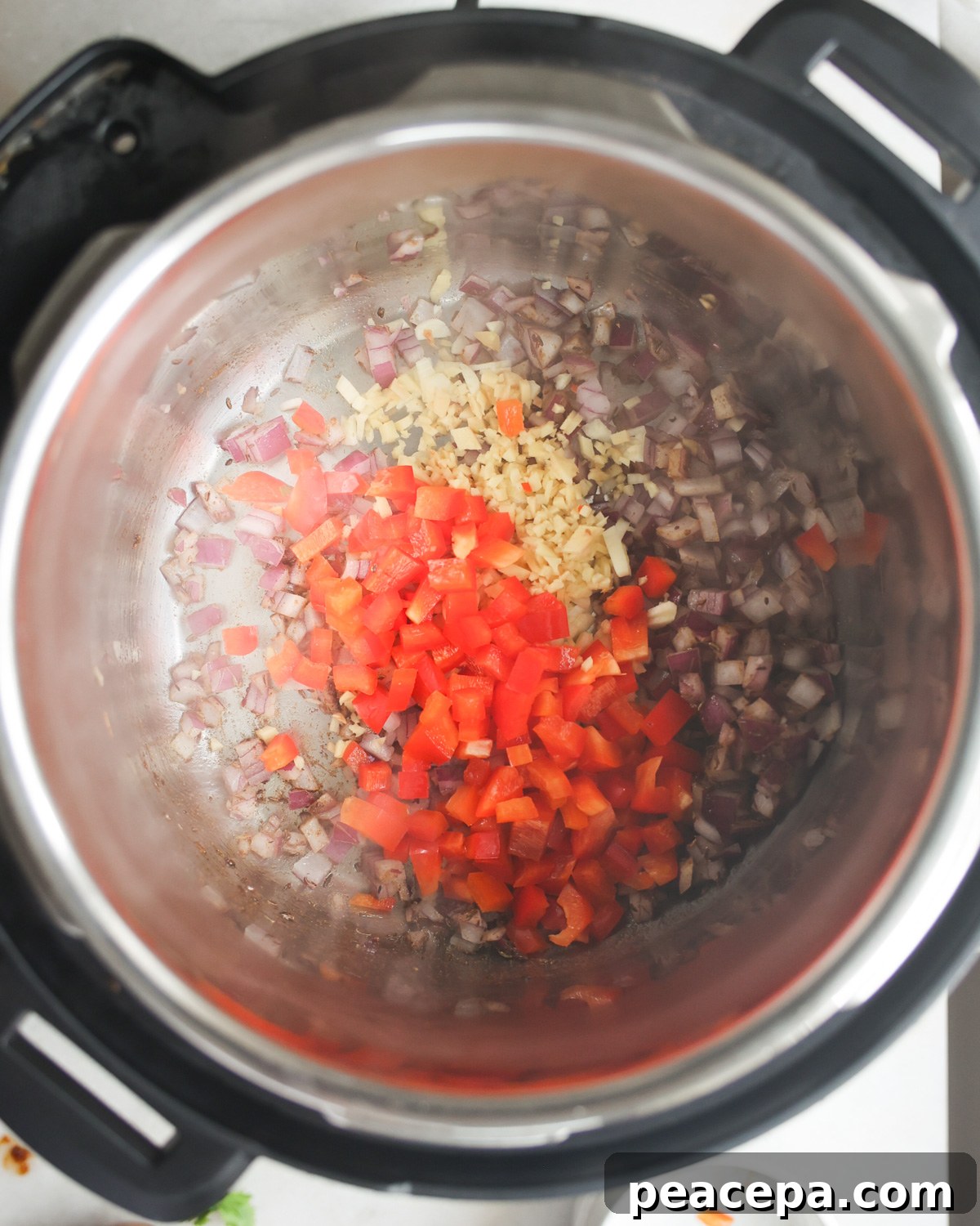 Vegetables sautéing in the pot.