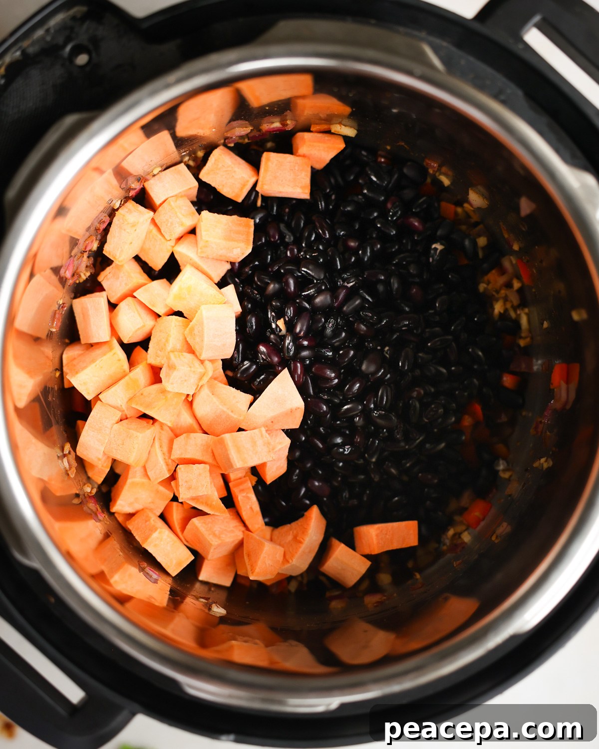 Black beans and sweet potato in pot.
