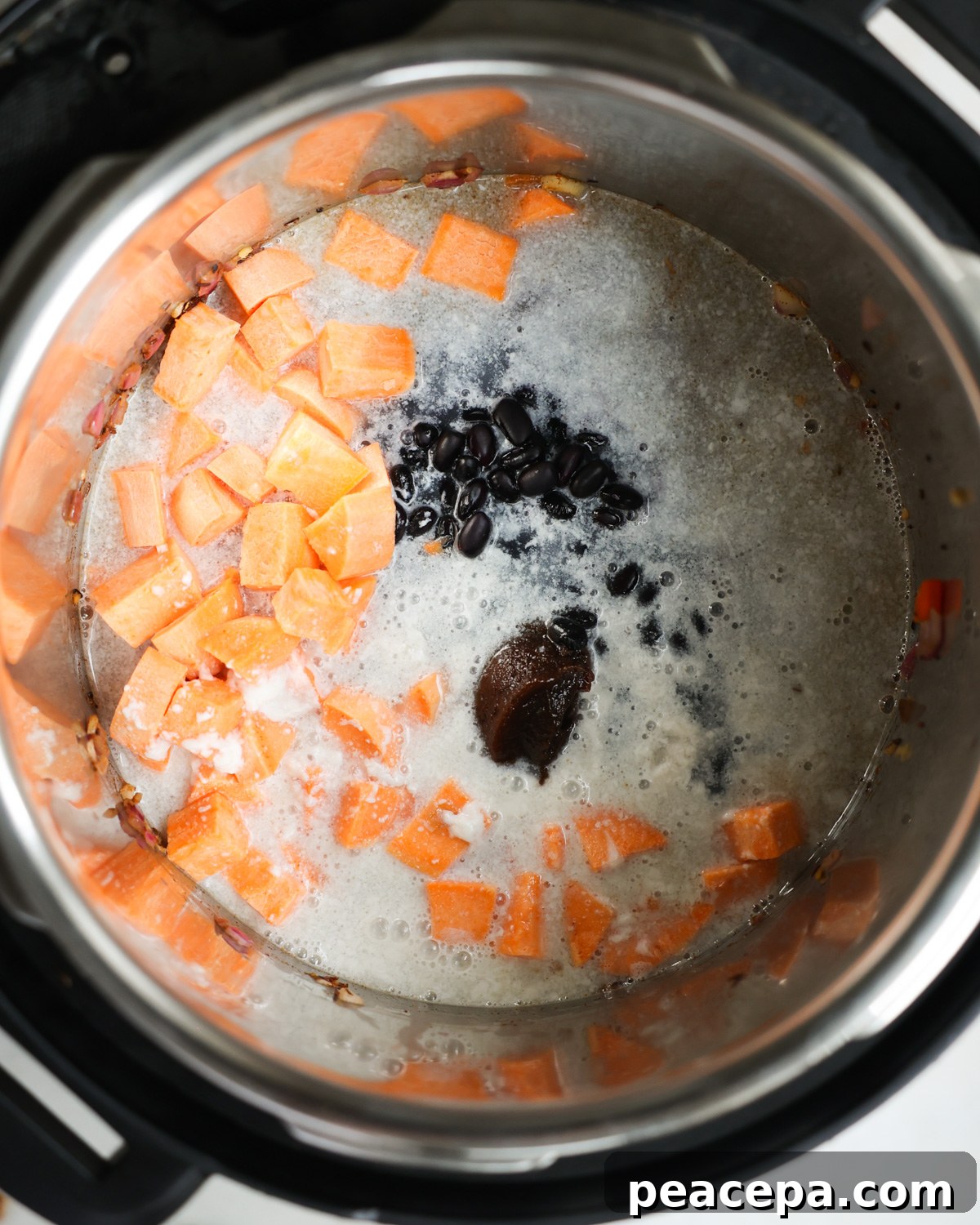 Coconut milk added to black beans in instant pot.