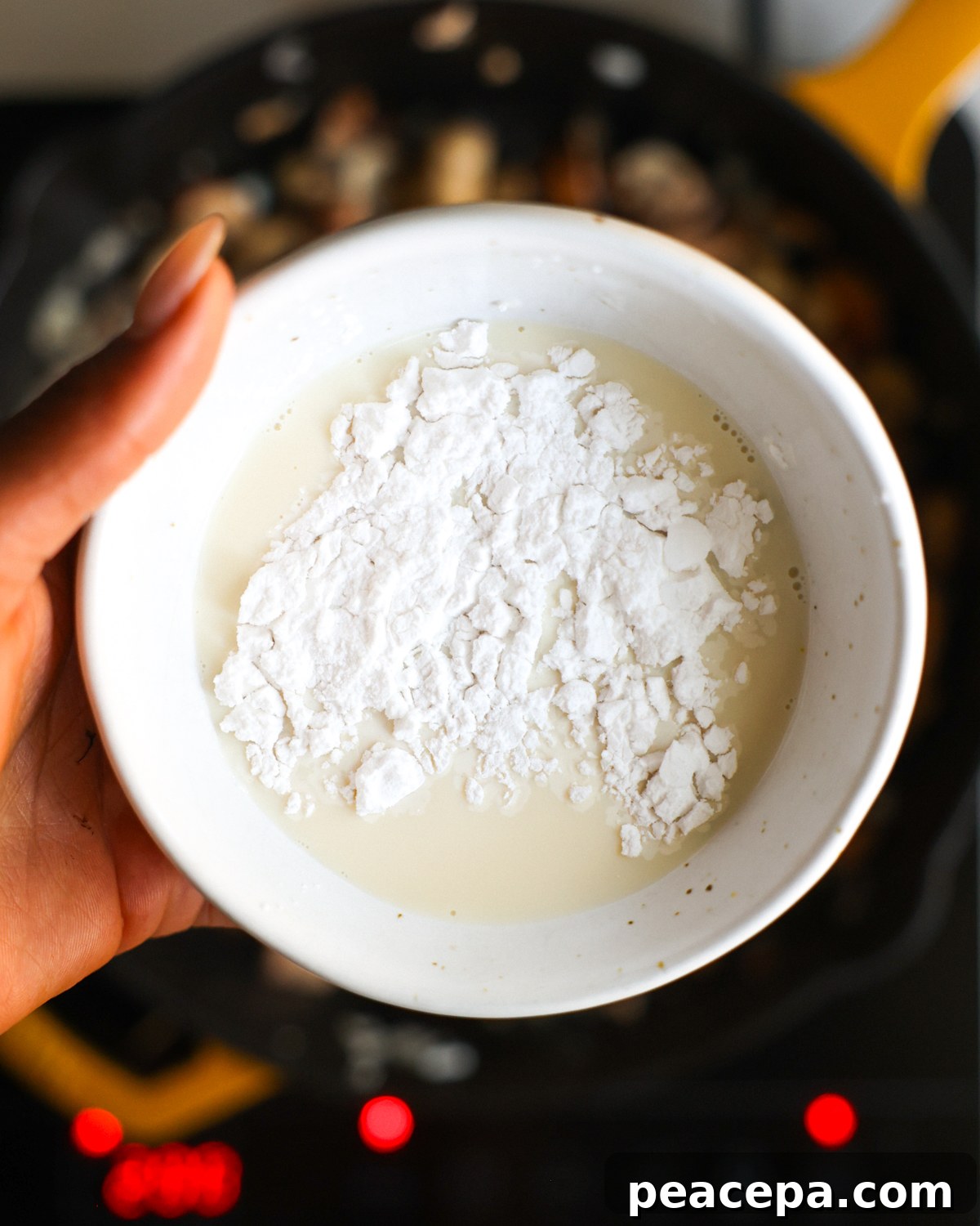 overhead soy milk and cornstarch in hand