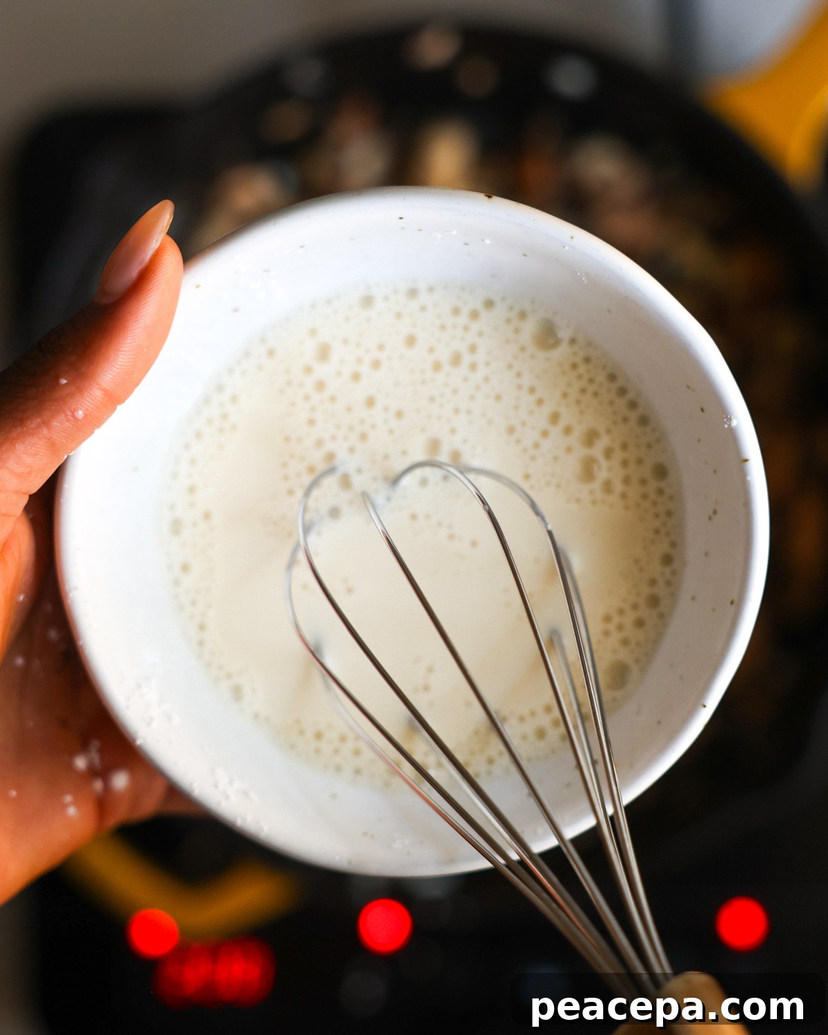 overhead whisking cornstarch slurry
