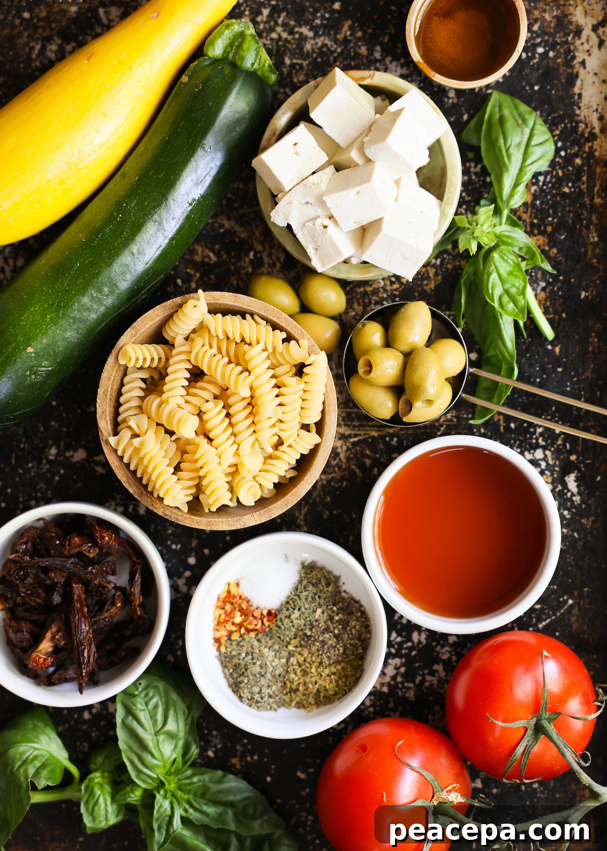 An overhead shot of all of the ingredients for Mediterranean pasta salad.