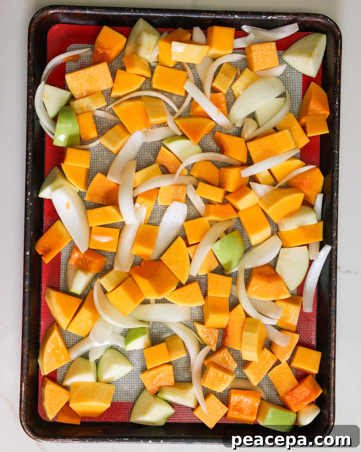 overhead of squash and apples on pan