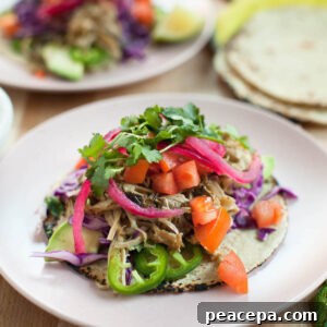 mushroom carnitas tacos on a light pink plate
