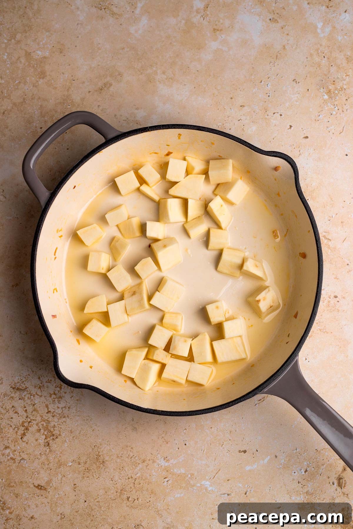 overhead of raw sweet potato in a skillet