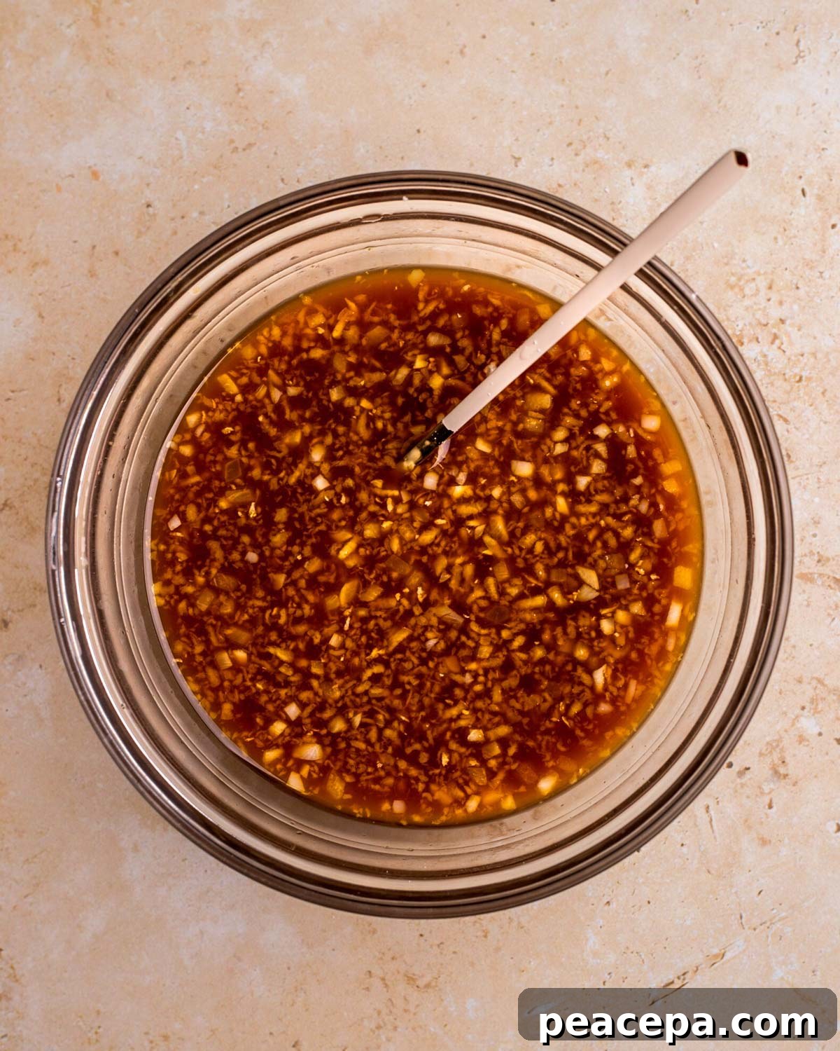 An overhead shot of a small mixing bowl of vegan teriyaki sauce.