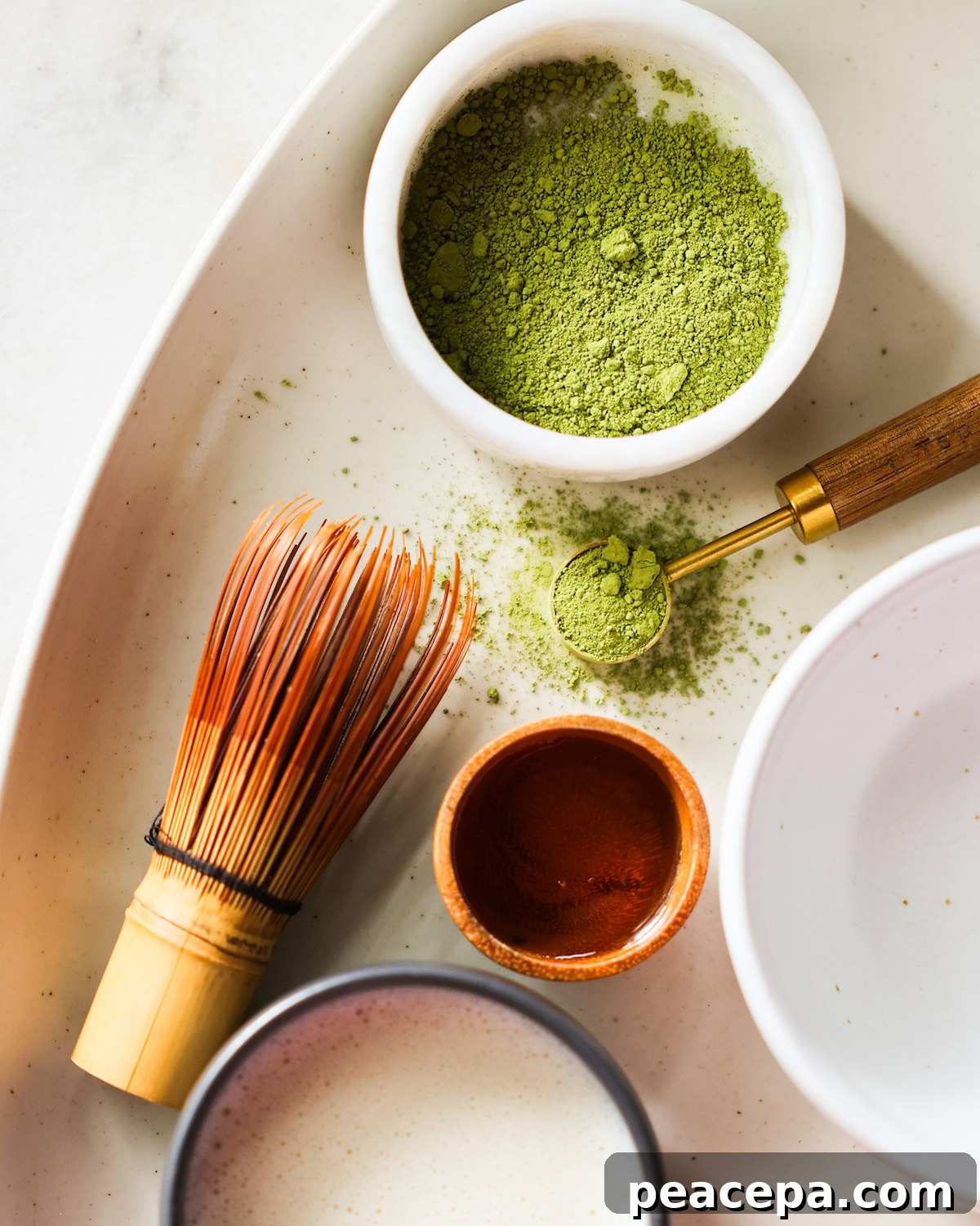 An overhead shot of all of the ingredients for the oat milk matcha latte.