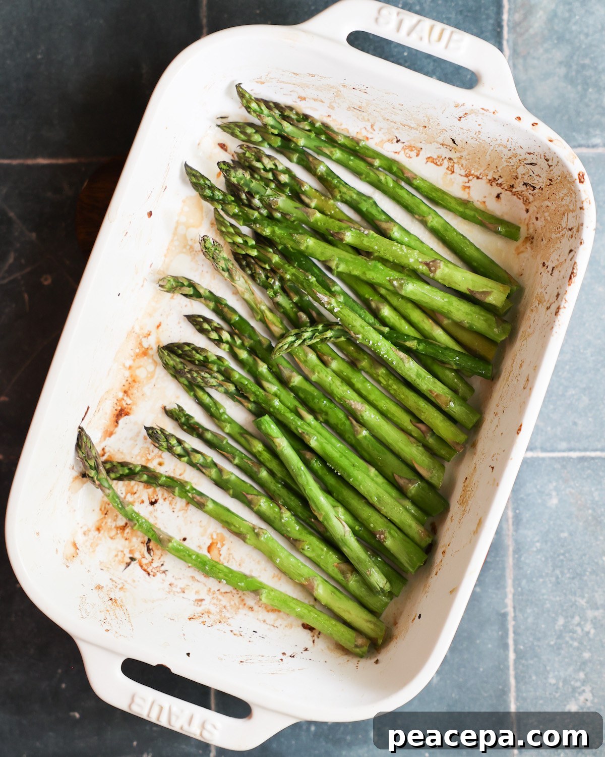 roasted asparagus in white baking dish