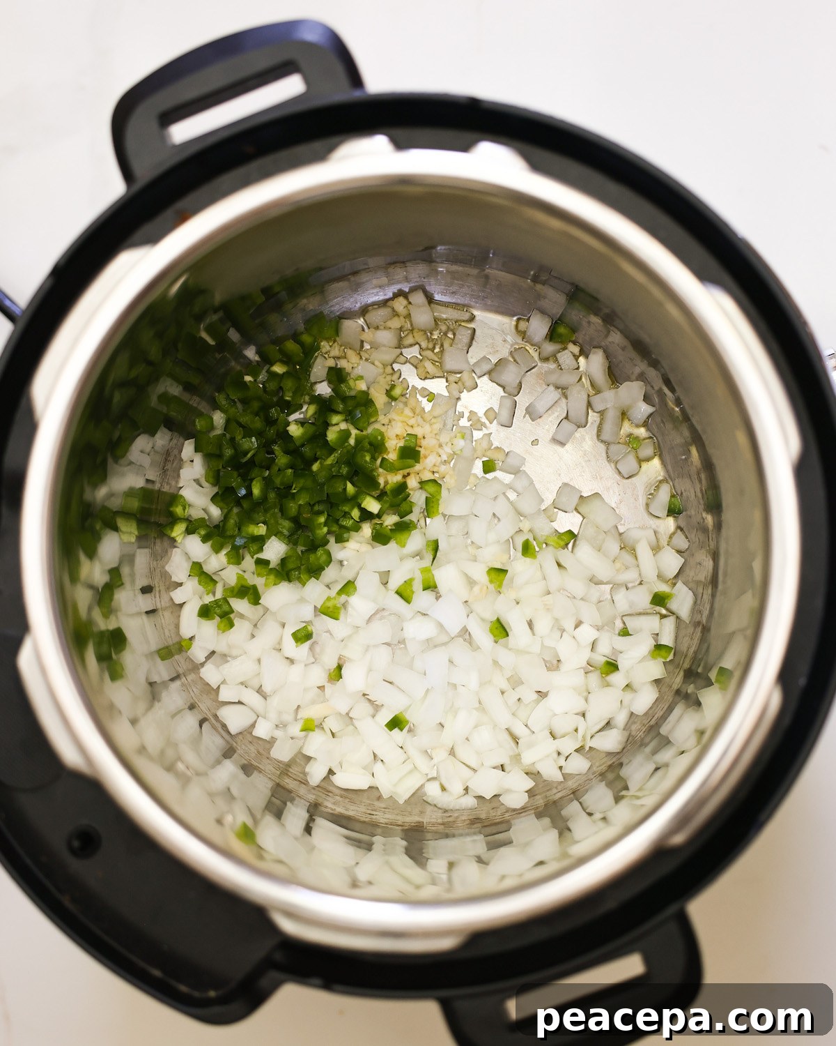 overhead of sautéing onions in Instant Pot