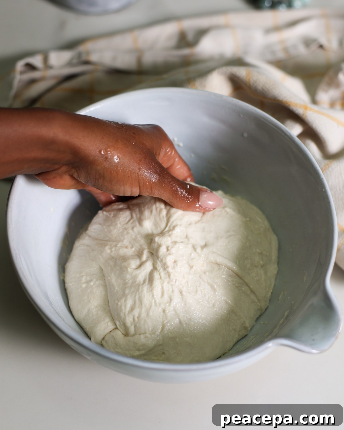 scooping dough to fold