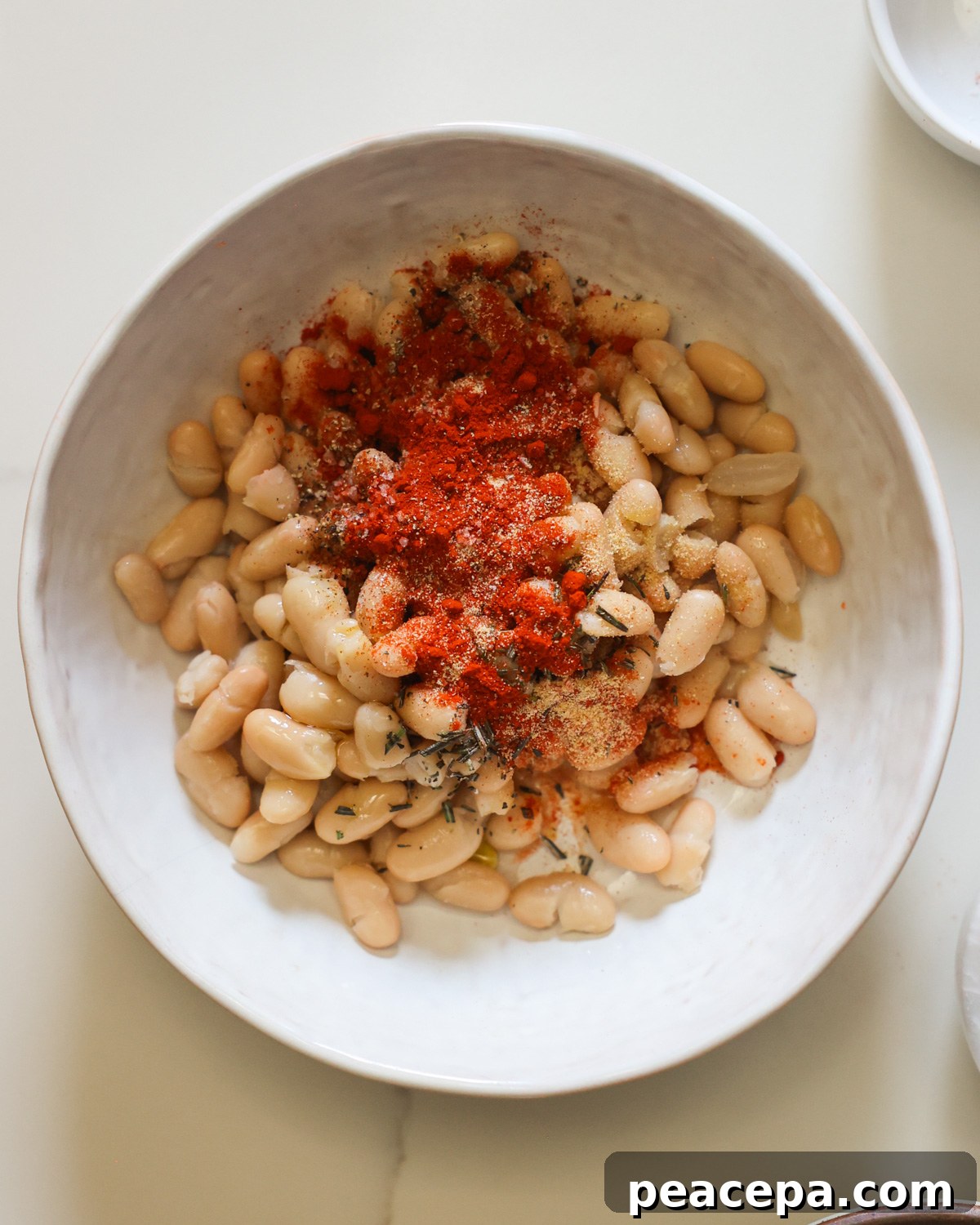 Spiced white beans in bowl. 