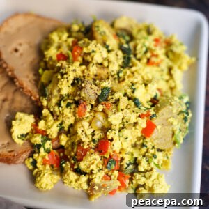 tofu scramble with toast on white plate