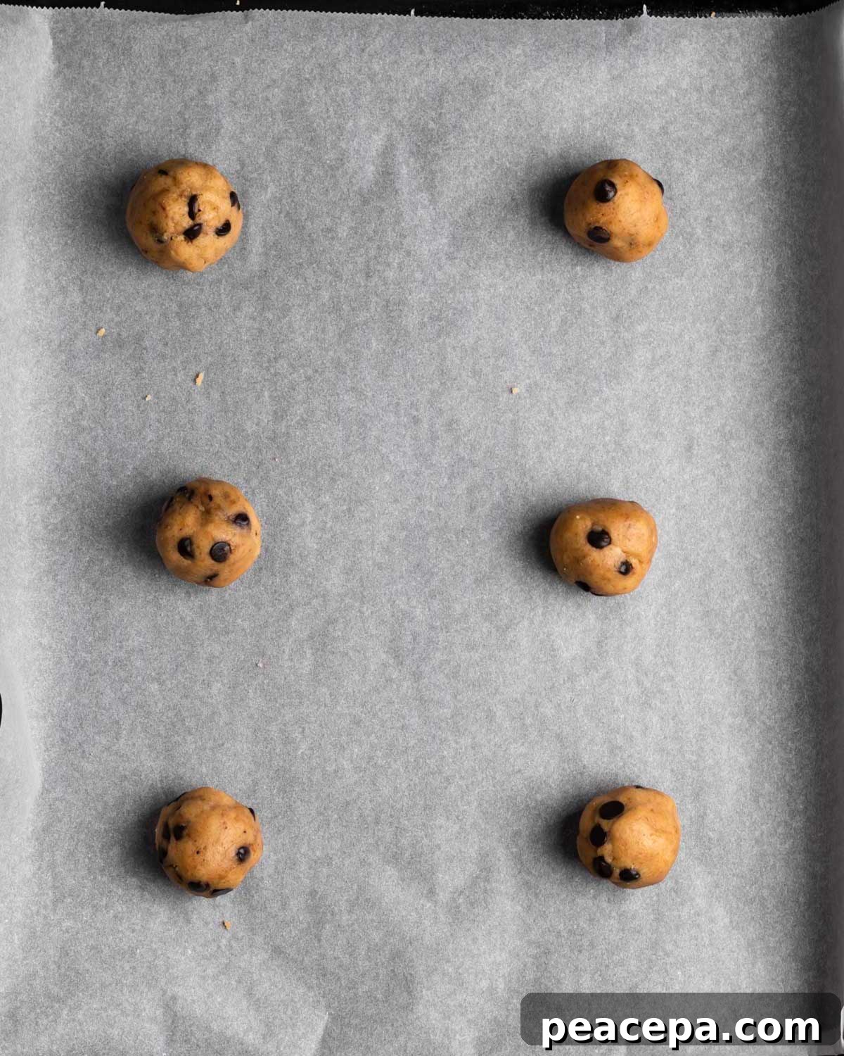 Vegan chocolate chip cookie dough balls on parchment paper