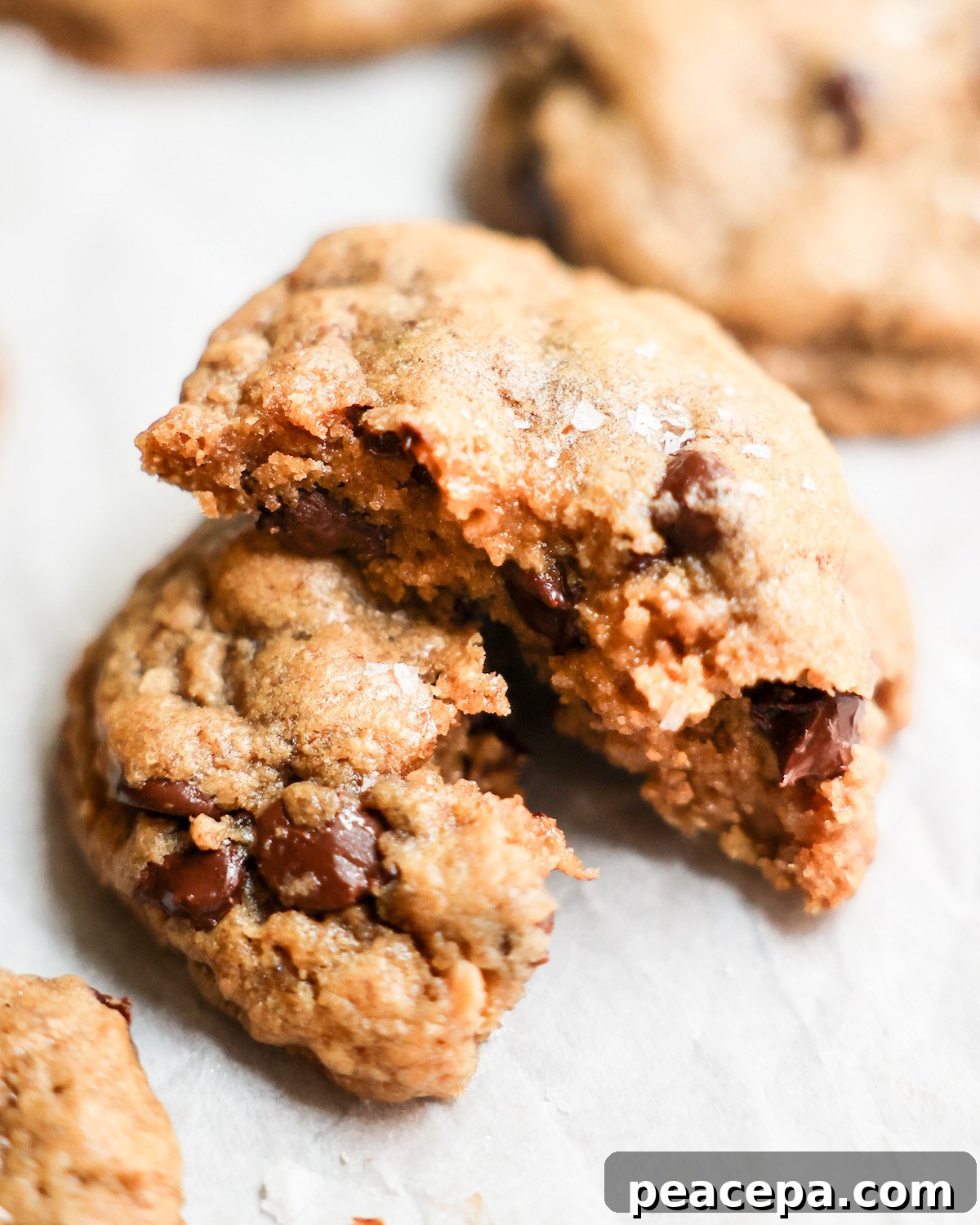 a vegan chocolate chip cookie cut in half and stacked
