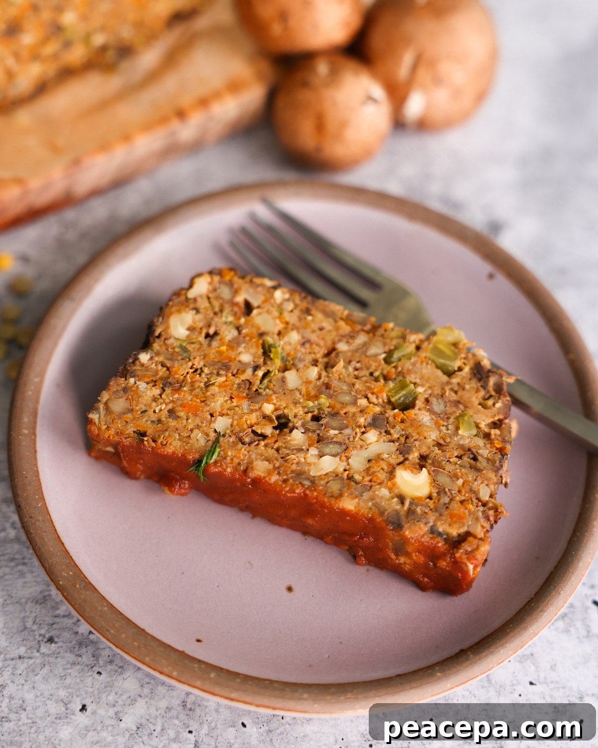 sliced vegan meatloaf on purple plate