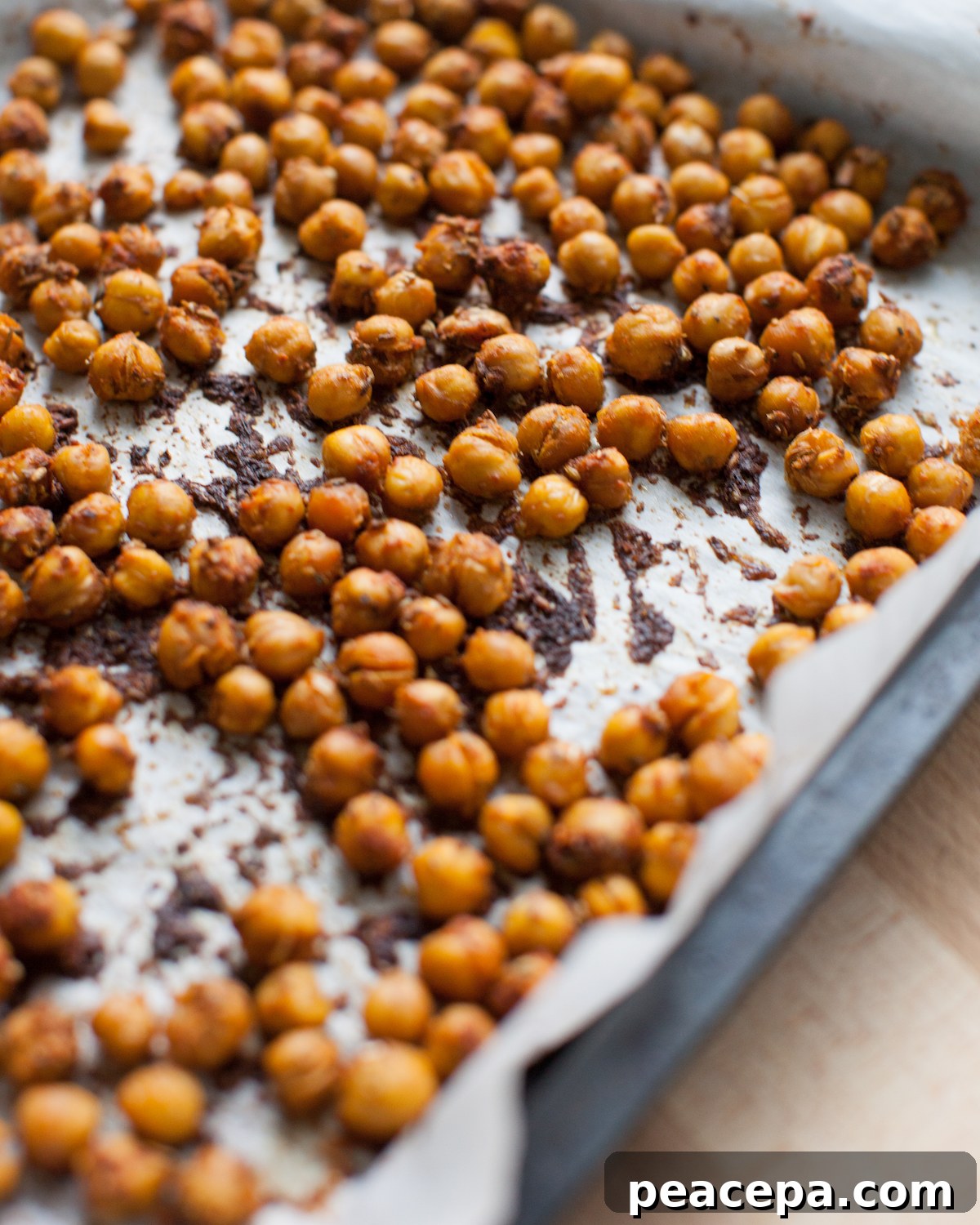 A baking tray of roasted chickpeas.