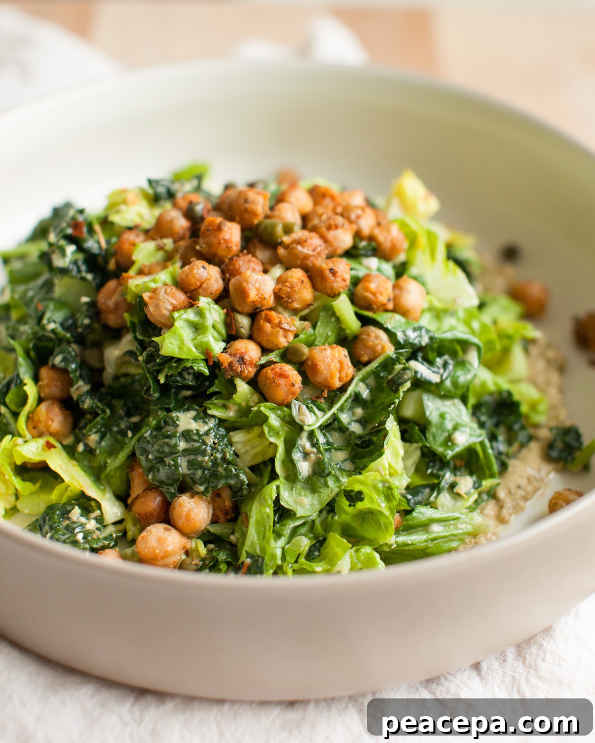 Vegan caesar salad in a white bowl.