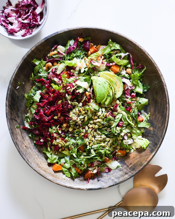 Large mixing bowl filled with Autumn Kale Salad.