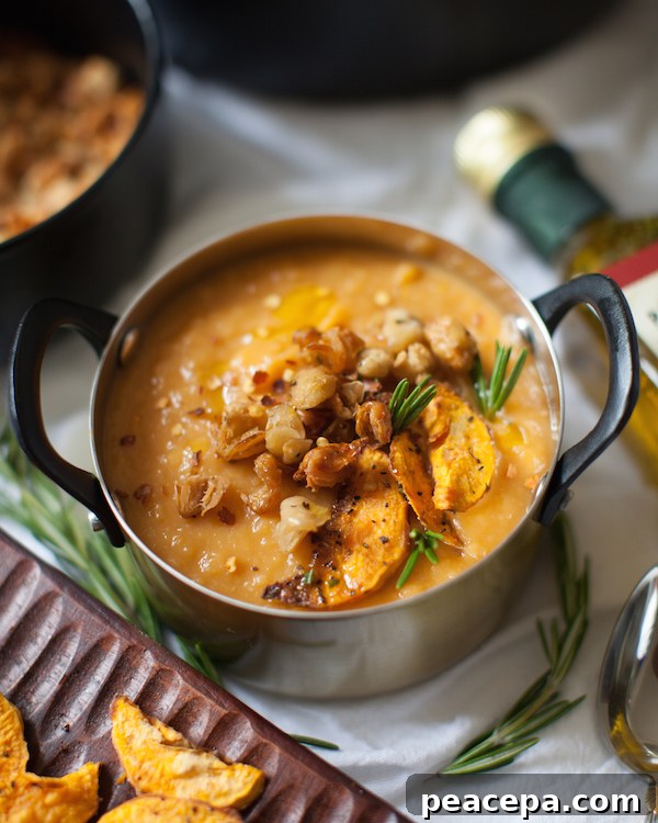 Pot of Sweet Potato Bisque topped with Crispy White Beans.