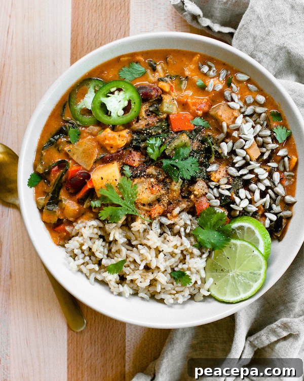 Bowl of Nut-Free West African Peanut Stew with rice and lime slices.
