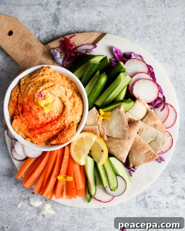 Platter of vegetables, pita bread, and a bowl of Sweet Potato Hummus.